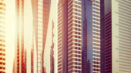 Color toned picture of modern buildings facades at sunset, architectural background.の写真素材