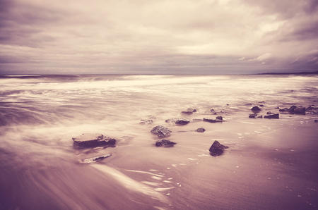 Scenic beach picture, motion blurred water, peaceful natural background, color toning applied.の写真素材