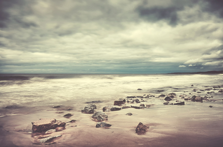 Scenic beach picture, motion blurred water, peaceful natural background, color toning applied.の写真素材