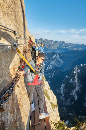 Mount Hua, Shaanxi Province, China - October 6, 2017: Tourists on the Plank Walk in the Sky, worlds most dangerous hike.のeditorial素材