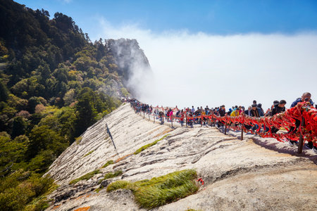 Mount Hua, Shaanxi Province, China - October 06, 2017: Tourists queue to climb Huashan mountain, one of the top travel destinations in China, during the National Day Golden Week holiday.のeditorial素材