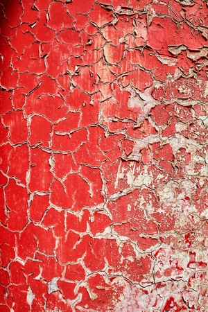 Cracking and peeling paint on a wall, background or texture, selective focus.の写真素材