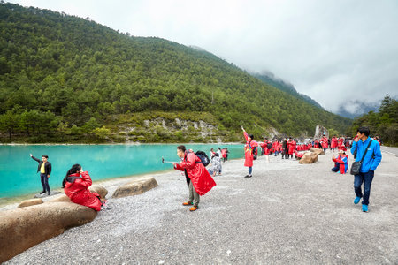 Lijiang, China - September 22, 2017: Tourists at the White Water River in Blue Moon Valley, one of the China top travel destinations.のeditorial素材