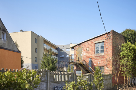 Old and modern houses, urban development process.の写真素材