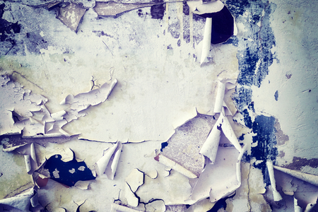 Wall with peeling paint, grunge background, color toned picture.の写真素材