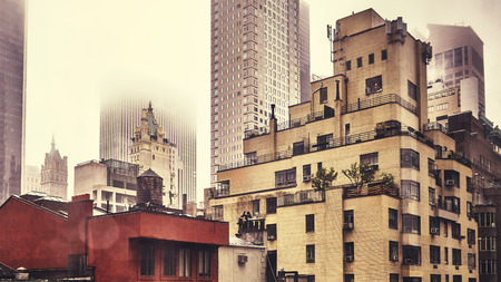New York City old residential buildings on a rainy day, retro stylized picture.の写真素材