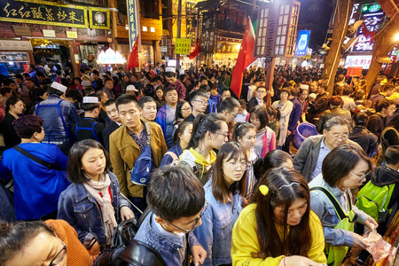Xian, China - October 5, 2017: Crowded people wait to order street food in the Muslim Quarter, well-known tourism site famous for its culture and food.のeditorial素材