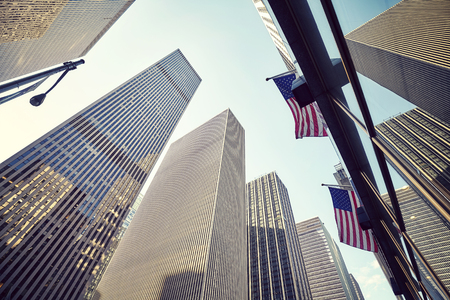 Looking up at New York skyscrapers at sunset, color toned picture, USA.の写真素材