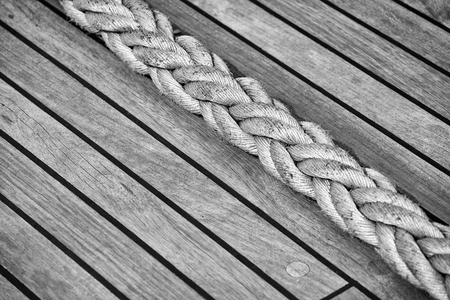 Thick rope on an old sailing ship wooden deck, selective focus.の写真素材