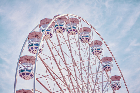 Retro toned picture of a Ferris wheel in an amusement park.の写真素材