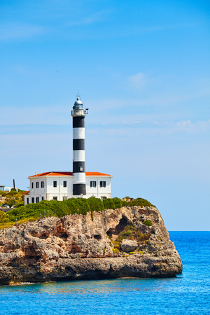 Portocolom Lighthouse on a cliff, Mallorca, Spain.の写真素材