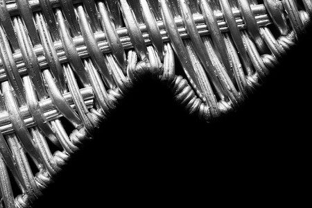 Black and white close up picture of silver painted wicker pattern, selective focus, space for text.の写真素材