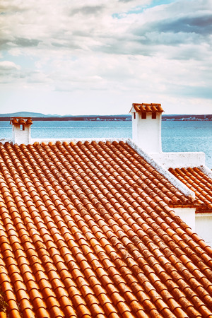 Retro stylized picture of an old ceramic tile roof, Mallorca, Spain.の写真素材
