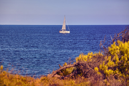 Lonely sailboat on Mallorca coast, color toned picture, Spain.の写真素材