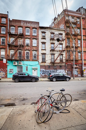New York City, USA - July 06, 2018: Broken bikes by a street in Williamsburg, one of Brooklyn boroughs that has undergone gentrification characterized by hipster culture.のeditorial素材