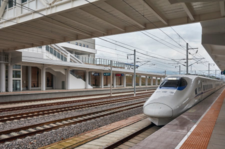 Shilin, China - September 21, 2017: High-speed train departs from Shilin station. With railway network about 28 000 km long in 2018, High-speed rail (HSR) network is to reach 38 000 km by year 2025.のeditorial素材