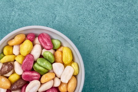 Colorful candies in a bowl, space for text.の写真素材