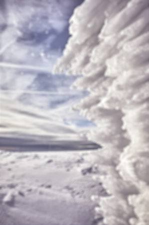 Blurred snowy mountain scenery with ice formations, winter abstract background, color toning...