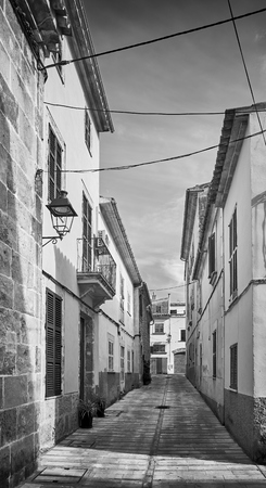 Black and white picture of a narrow street in Alcudia old town, Mallorca, Spain.の写真素材