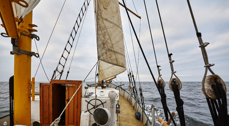 Sailing an old schooner on a rainy day.