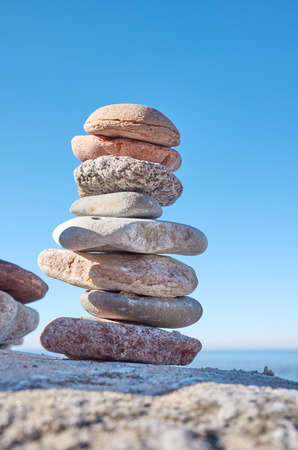 Stack of stones on a beach, balance and harmony concept, selective focus.の写真素材