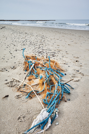 Plastic garbage on a beach, selective focus.の写真素材