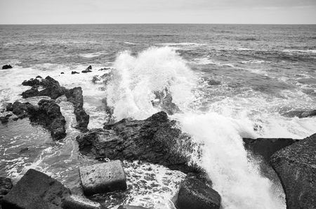 Black and white picture of waves crashing on rocks, Tenerife, Spain.