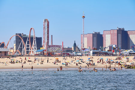 New York, USA - July 02, 2018: Crowded Coney Island beach and amusement parks seen from the pier on a sunny day.のeditorial素材