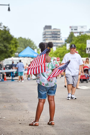 New York, USA - July 04, 2018: Woman with American Flags during federal holiday in the United States commemorating the Declaration of Independence.のeditorial素材