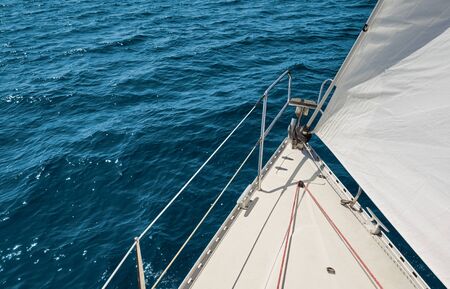 Picture of a sailboat bow and sail.