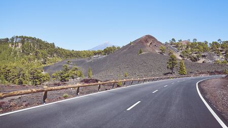 Scenic road with Teide Volcano in distance, color toning applied, Tenerife, Spain.の写真素材