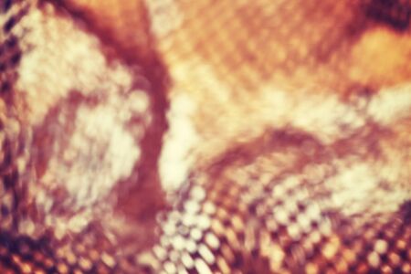 Abstract blurred background, picture of defocused perforated brown paper.の写真素材