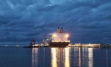 Illuminated ship in a port at dusk, lens flares effect.の写真素材