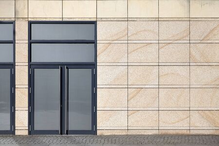 Front view of a building wall with closed door.の写真素材