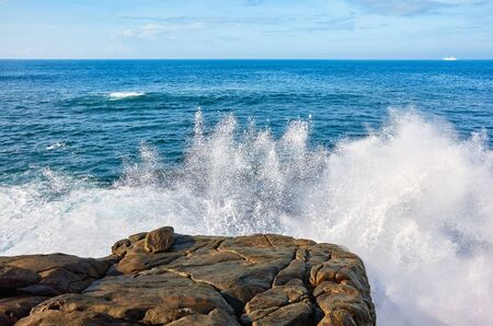 Waves crashing against the rocky shore, Sri Lanka.