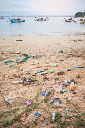 Mirissa, Sri Lanka - December 23, 2019: Beach by the harbor polluted mainly by plastic bottles.のeditorial素材