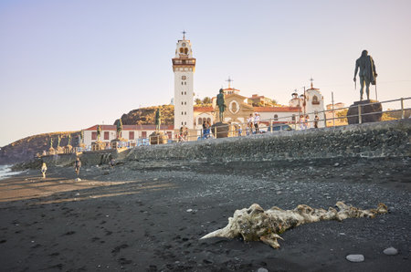 Candelaria, Tenerife, Spain - May 01, 2019: The Basilica of the Royal Marian Shrine of Our Lady of Candelaria  seen from volcanic beach at sunset. It is the first Marian shrine of the Canary Islands.のeditorial素材
