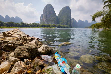 Xingping, China - September 18, 2017: Plastic garbage at the bank of Li River, one of China top...