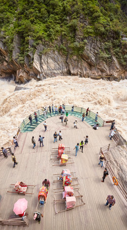 Jizha, China - September 24, 2017: People at the Tiger Leaping Gorge rough waters viewpoint. It is part of the Three Parallel Rivers of Yunnan Protected Areas World Heritage Site.のeditorial素材