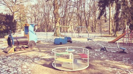 Retro toned picture of an empty outdoor playground in winter.の写真素材