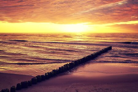 Scenic sunset over sea, Baltic Sea in Mrzezyno, color toning applied, Poland.