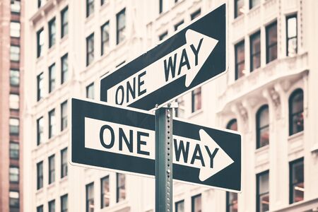 One way street arrow signs in New York City, color toning applied, USA.の写真素材