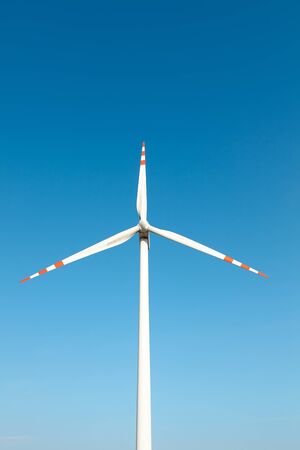 Wind turbine against the blue sky.
