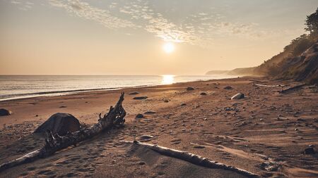 Sunrise over beach near Miedzyzdroje, color toning applied, Poland.