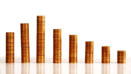 Stacks of old golden coins arranged as a chart on white background.