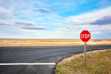 Stop road sign at an intersection in Badlands National Park, South Dakota, USA.