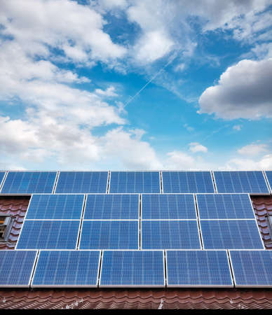 Solar photovoltaic panels on a roof of a house.