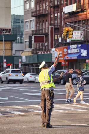 New York, USA - June 29, 2018: NYPD traffic enforcement agent performs work on Manhattan intersection.のeditorial素材