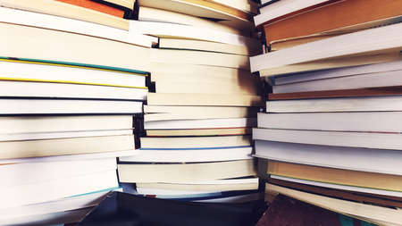 Piles of old books, selective focus, color toning applied.の写真素材