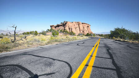 Scenic road with rock formations, color toned picture, travel concept, Colorado National Monument...